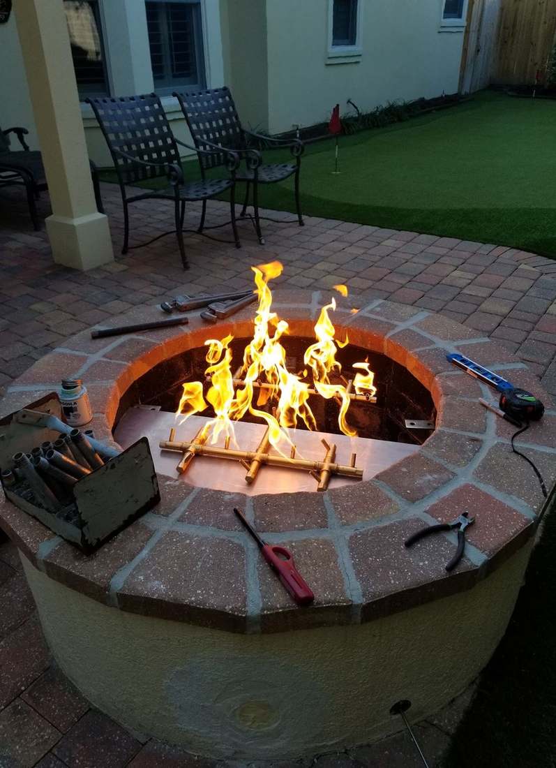 Alpha Gas Services technician testing a fire pit burner